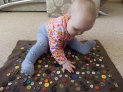 Developing mat with buttons for the baby
